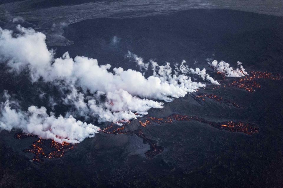 Picture shows magma along a 1-km-long fissure in a lava field north of the Vatnajokull glacier, which covers part of Bardarbunga volcano system, August 29, 2014. The eruption is at the tip of a magma dyke around 40 km from the main Bardarbunga crater and activity subsided to relatively low levels after peaking between 0020 and 0200 GMT, Iceland Met Office seismologist Martin Hensch said. Iceland's Meteorological Office on Friday downgraded its volcano alert level to orange from red and said a small eruption that started during the night is not a threat to aviation. REUTERS/Marco Nescher (ICELAND - Tags: ENVIRONMENT TPX IMAGES OF THE DAY)