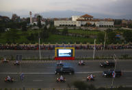 The motorcade of Chinese President Xi Jinping drives past the Nepalese parliament in Kathmandu, Nepal, Saturday, Oct 12, 2019. Xi has become the first Chinese president in more than two decades to visit Nepal, where he's expected to sign agreements on major infrastructure projects. (AP Photo/Niranjan Shrestha)