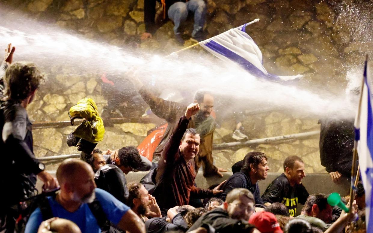 A water cannon is used against demonstrators in Tel Aviv