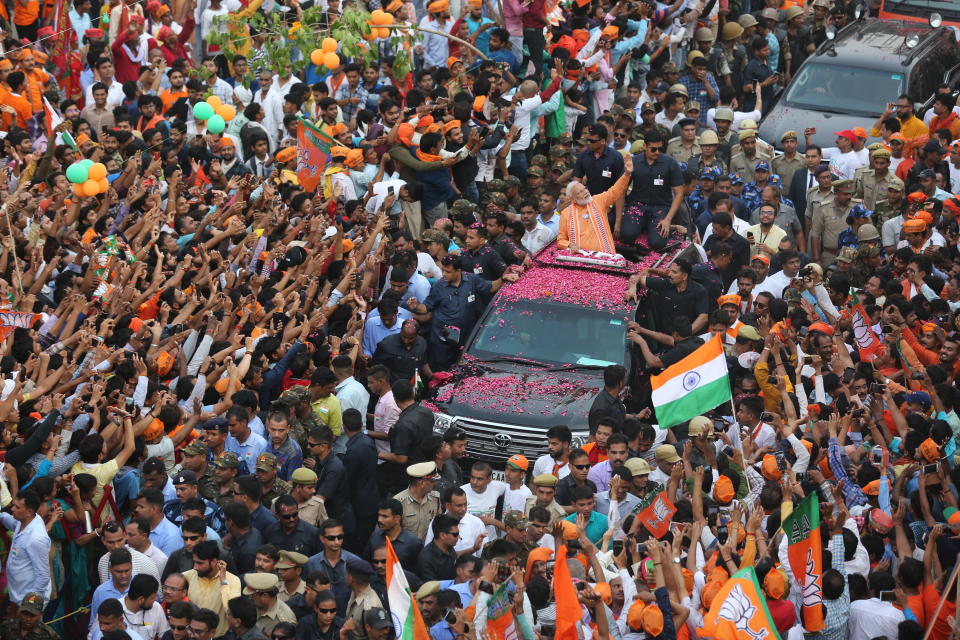 FILE - In this April 25, 2019 file photo, Indian Prime Minister Narendra Modi waves to the crowd during a political campaign road show in Varanasi, India. The final phase of India’s marathon general election will be held on Sunday, May 19. The first of the election’s seven staggered phases was held on April 11. Vote counting is scheduled to start on May 23. India has 900 million eligible voters. (AP Photo/ Rajesh Kumar Singh, File)