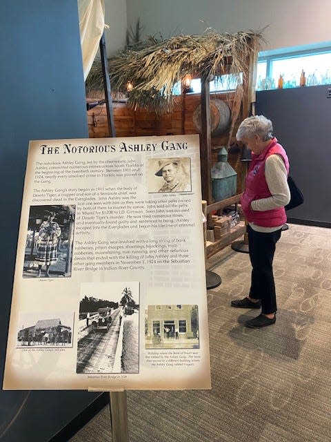 A guest looks at a replica of one of the Ashley Gang's camps at a new exhibit at the Elliott Museum in Stuart.