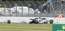 Alpha Tauri driver Daniil Kvyat of Russia stands on the right after crashing during the British Formula One Grand Prix at the Silverstone racetrack, Silverstone, England, Sunday, Aug. 2, 2020. (Andrew Boyers/Pool via AP)