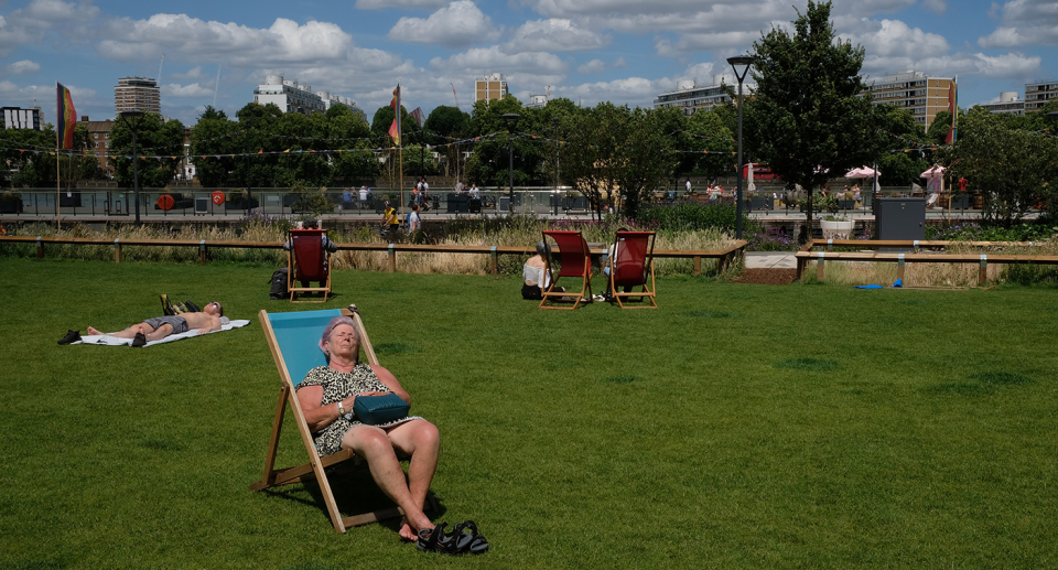 People relaxing in a park in London during a heatwave in 2022.