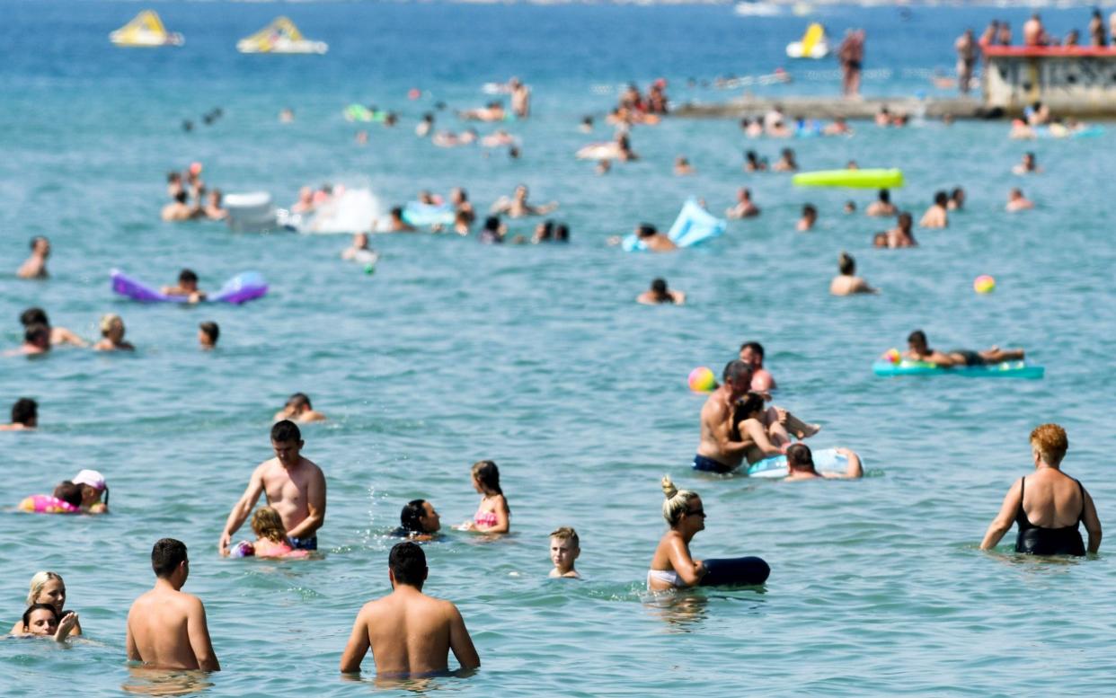 Crowds of people, mostly foreign tourists, enjoy the beach, sunbath and swim in the sea on August 13, 2020, in Crikvenica on the northern Adriatic coast. - On August 13, 180 new cases of coronavirus infection have been recorded in Croatia, the highest since the beginning of the pandemic. Italy has already introduced mandatory testing for all who come from Croatia. (Photo by DENIS LOVROVIC / AFP) (Photo by DENIS LOVROVIC/AFP via Getty Images) - Denis Lovrovic/Getty Images
