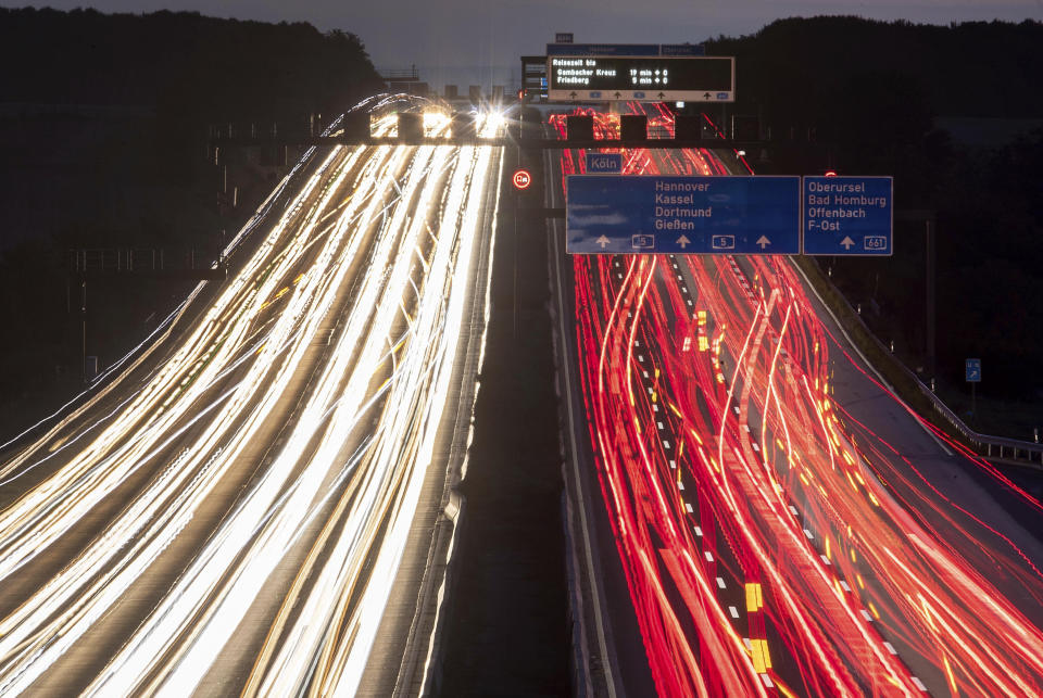 FILE -- In this Thursday, Sept. 19, 2019 long time exposure photo cars drive on a highway in Frankfurt, Germany. Germany's parliament is poised to more than double the starting price for carbon dioxide emissions from the transport and heating industries when the charge is introduced in 2021. (AP Photo/Michael Probst)