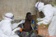 In this Saturday, Sept. 29, 2007, file photo, A 43 year old Congolese patient, center, who has been confirmed to have Ebola hemorrhagic fever, following laboratory tests, is comforted by Medecins Sans Frontieres (Doctors without Borders) nurse Isabel Grovas, left, and Doctor Hilde Declerck, right, in Kampungu, Kasai Occidental province, Congo. An outbreak of the deadly Ebola virus is believed to have killed at least 59 people in Guinea and may already have spread to neighboring Liberia, health officials said Monday, March 25, 2014. (AP Photo/WHO, Christopher Black, HO, File)