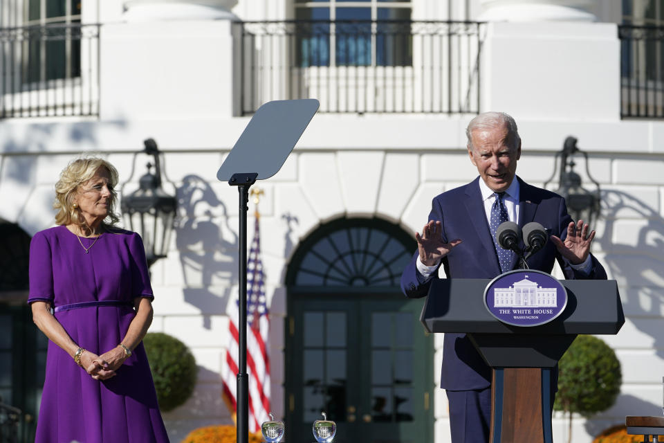 First lady Jill Biden, left, listens as President Joe Biden, right, speaks to the 2020 and 2021 State and National Teacher of the Year recipients during an event on the South Lawn of the White House in Washington, Monday, Oct. 18, 2021. (AP Photo/Susan Walsh)