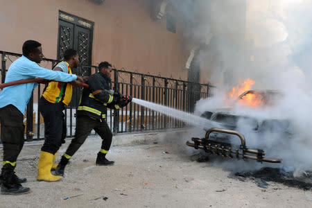 Fire fighters attempt to extinguish a burning car after an explosion in Mogadishu, Somalia September 22, 2018. REUTERS/Feisal Omar