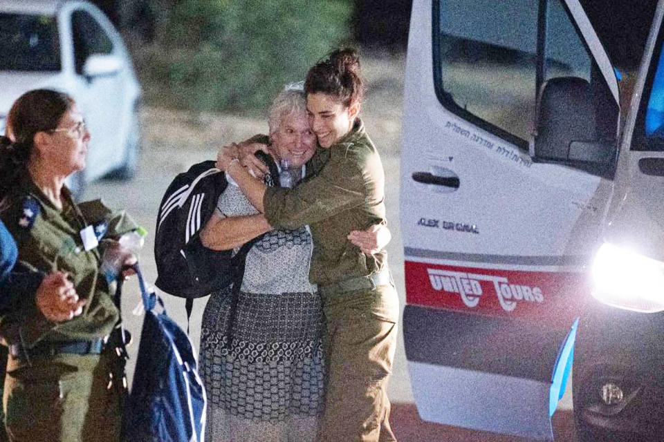 An Israeli soldier embraces former Hamas hostage as she exists a van (Israel Army / AFP via Getty Images)