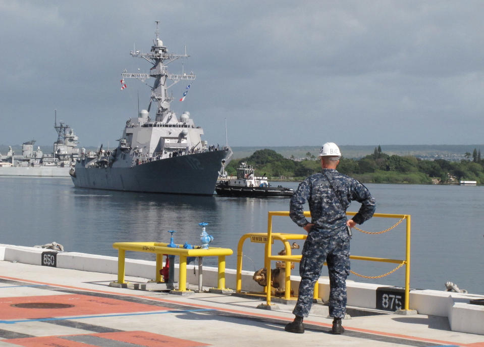 American naval destroyer USS Michael Murphy escorts passengers from a Canadian navy vessel to Pearl Harbor, Hawaii on Tuesday, March 4, 2014. A U.S. Navy ocean tug was towing the Canadian ship after an engine fire left 20 sailors with minor injuries. (AP Photo/Oskar Garcia)