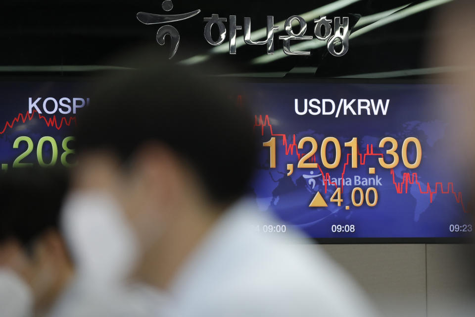 Currency traders watch computer monitors near screens showing the Korea Composite Stock Price Index (KOSPI), left, and the foreign exchange rate between U.S. dollar and South Korean won at the foreign exchange dealing room in Seoul, South Korea, Friday, July 24, 2020. Worsening China-U.S. friction, worries over aid to Americans and U.S. businesses and a stumble on Wall Street combined to push shares in Asia lower on Friday. (AP Photo/Lee Jin-man)