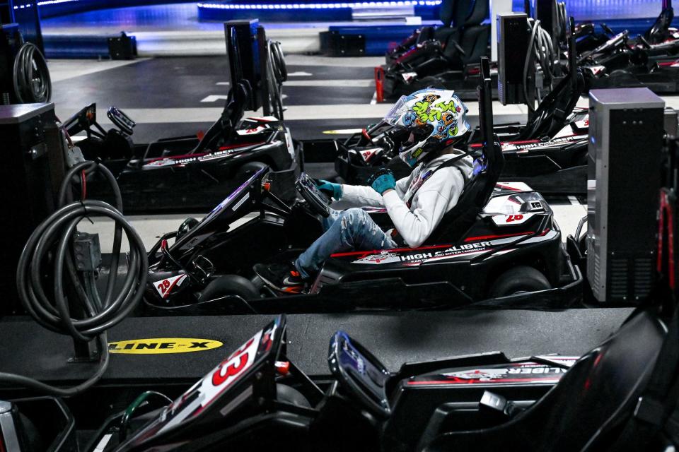 Payne Clinkscales prepares his vehicle before racing a go-kart at High Caliber Karting and Entertainment on Wednesday, Nov. 29, 2022, at the Meridian Mall in Okemos.