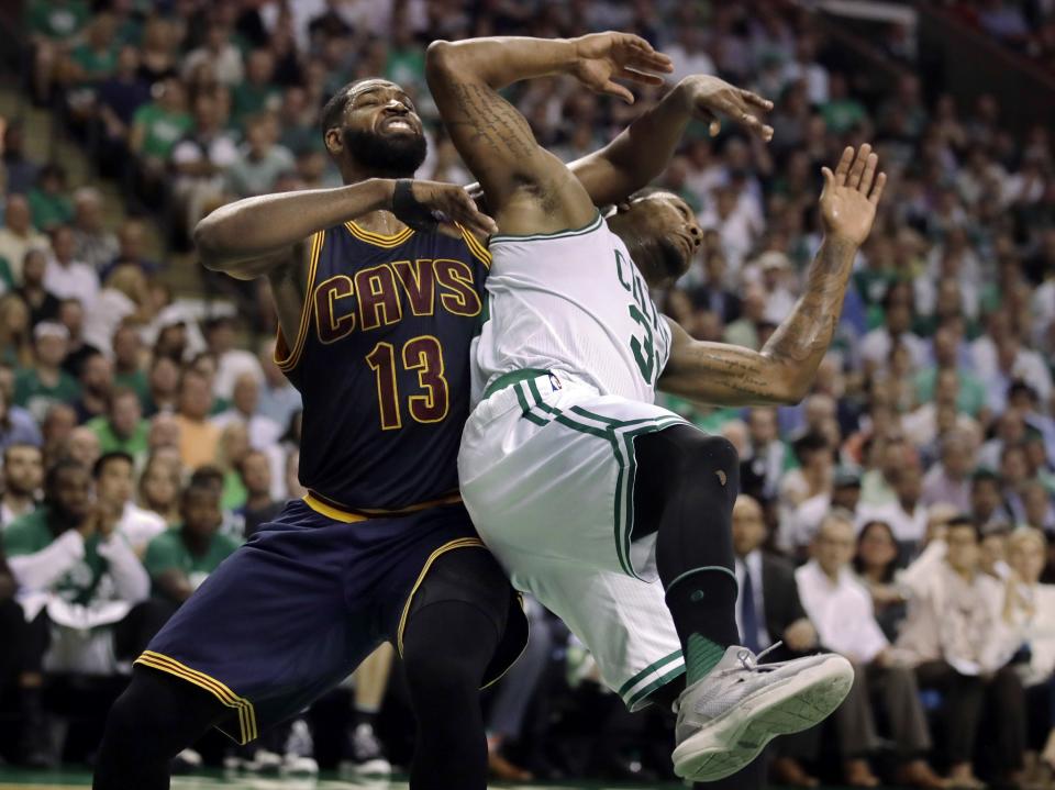 Cleveland Cavaliers center Tristan Thompson (13) and Boston Celtics guard Marcus Smart tangle during the third quarter of Game 1 of the NBA basketball Eastern Conference finals, Wednesday, May 17, 2017, in Boston. (AP Photo/Charles Krupa)