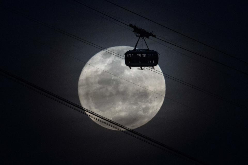 The second supermoon of 2023, also known as the Sturgeon Moon, rises behind the cable car of the Sugar Loaf mountain in Rio de Janeiro, Brazil, on August 1, 2023. Algonquian native American tribes from the Great Lakes region of the United States named this full moon ‘Sturgeon Moon’ because of the abundance of sturgeon fish in this period of the year. (Photo by MAURO PIMENTEL / MAURO PIMENTEL / AFP) (Photo by MAURO PIMENTEL/MAURO PIMENTEL/AFP via Getty Images)