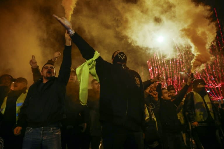 Demonstrators faced riot police on the Champs Elysees at the end of a protest by the French "yellow vests" (gilets jaunes) movement in central Paris on December 22