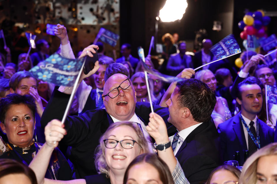 Supporters of the Sweden Democrats celebrate at the party's election watch at the Elite Hotel Marina Tower in Nacka, near Stockholm, Sweden, Sunday, Sept. 11, 2022. An exit poll projected that Sweden’s ruling left-wing Social Democrats have won the most votes in a general election while a right-wing populist party had its best showing yet. (Stefan Jerrevång/TT News Agency via AP)