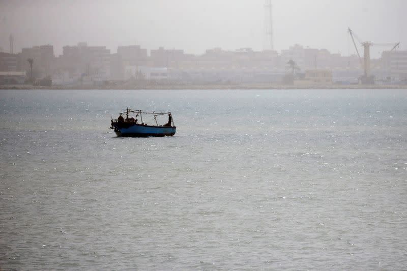 A boat is seen on a dusty weather in the Suez city near the Suez Canal