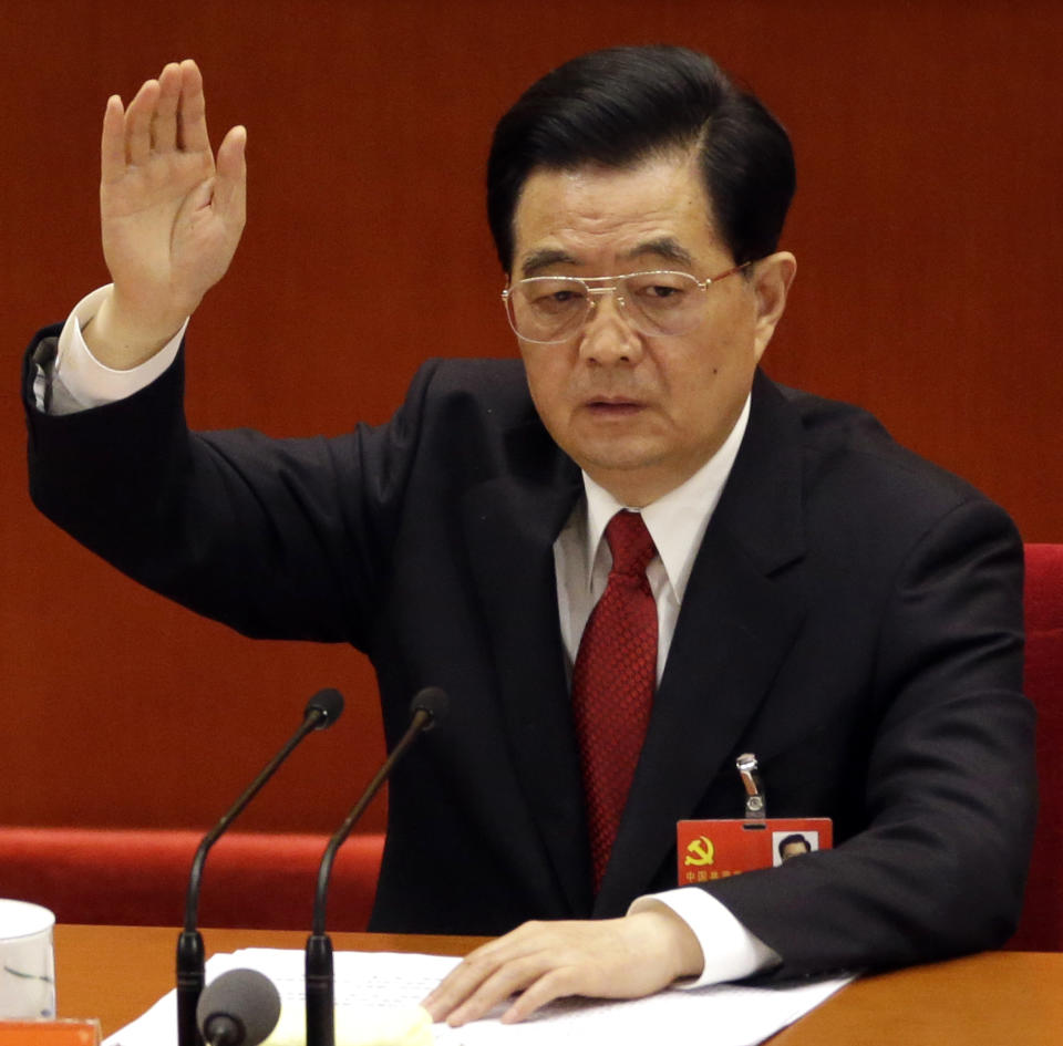 Chinese President Hu Jintao raises his hand to show approval for a work report during the closing ceremony for the 18th Communist Party Congress held at the Great Hall of the People in Beijing, China, Wednesday Nov. 14, 2012. (AP Photo/Lee Jin-man)