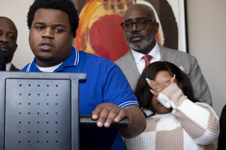 Treveon Isaiah Taylor Sr., father of a baby who was decapitated during delivery, speaks at a press conference as his wife Jessica Ross wipes away a tear, Wednesday, Feb. 7, 2024, at their lawyers office in Atlanta. (Ben Gray/Atlanta Journal-Constitution via AP)