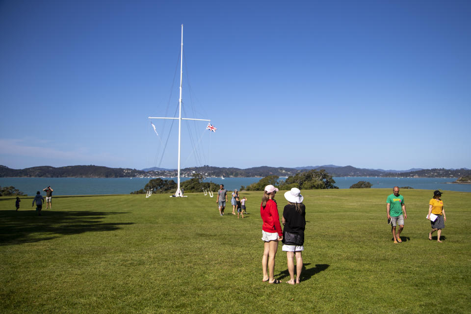 People walk on the Waitangi Treaty Grounds where the Treaty of Waitangi was first signed between Maori and the British Crown on Feb. 6, 1840, in Waitangi, northern New Zealand on Oct. 5, 2020. The debate in New Zealand over becoming a republic has an unusual twist: Many Indigenous Maori support New Zealand sticking with the monarchy, unlike the Indigenous people in many other former British colonies. That's because Maori signed a treaty with the British Crown in 1840 that guarantees them certain rights, and some Maori fear a constitutional change could threaten those rights. (AP Photo/Mark Baker)