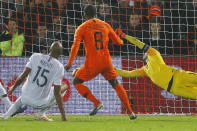 Netherlands' Georginio Wijnaldum, center, scores his side's first goal passing France's goalkeeper Hugo Lloris, right, during the international friendly soccer match between The Netherlands and France at De Kuip stadium in Rotterdam, Netherlands, Friday, Nov. 16, 2018. (AP Photo/Peter Dejong)