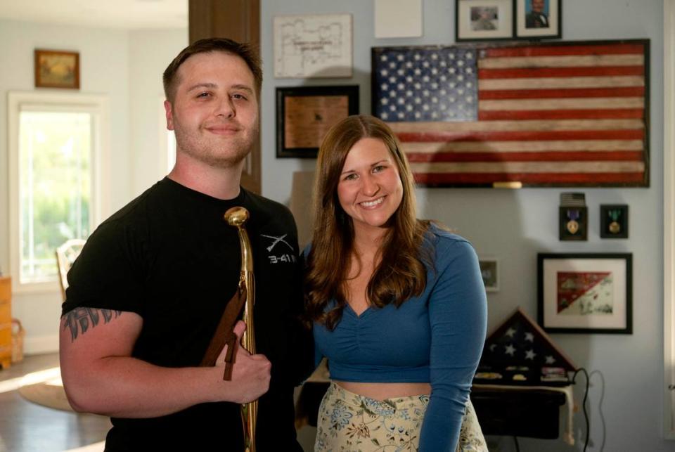 Adam Hartswick with his wife Sara in their home on Thursday, May 11, 2023.