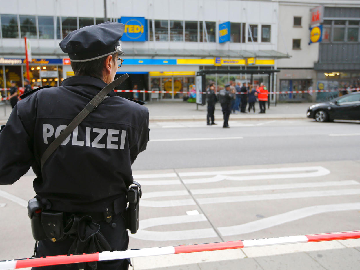 A police officer at the scene of the attack where one man was killed: Reuters