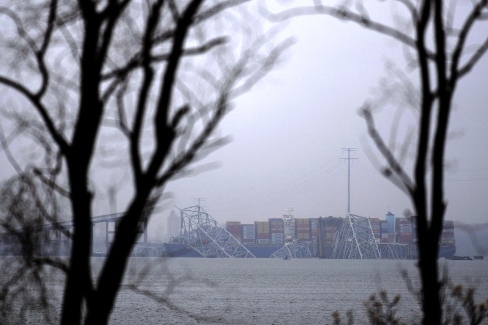 A container ship rests against the wreckage of the Francis Scott Key Bridge on Thursday, March 28, 2024, in Baltimore, Md. After days of searching through murky water for the workers missing after the bridge collapsed, officials are turning their attention Thursday to what promises to be a massive salvage operation. (AP Photo/Matt Rourke)