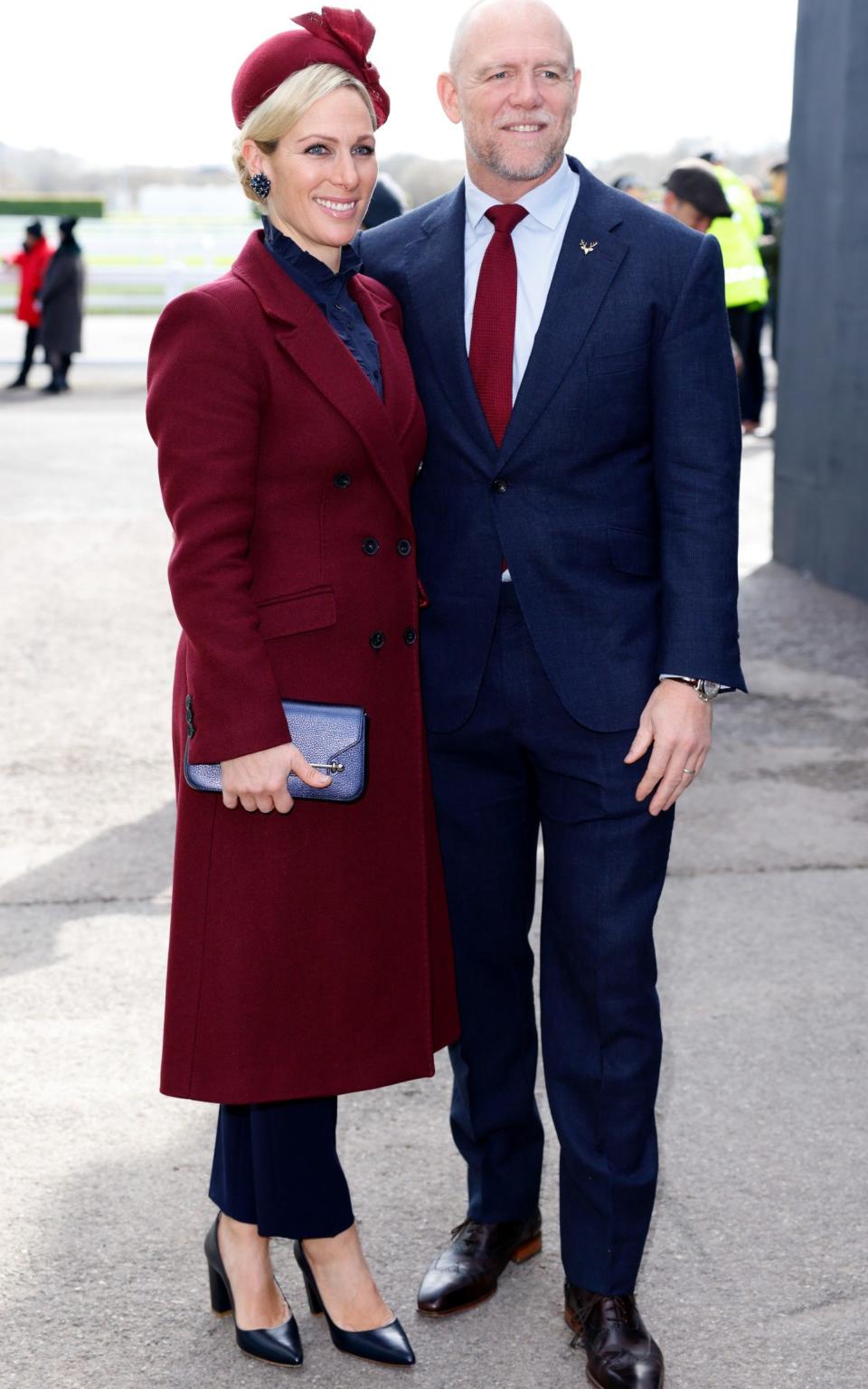 In 2023, pairing a smart trouser suit with a cheekbone-enhancing burgundy pillbox