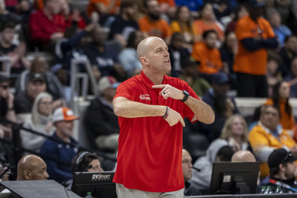 Western Kentucky head coach Steve Lutz signals in to his players during the first half of an NCAA college basketball game against UTEP at the Conference USA Tournament final, Saturday, March 16, 2024, in Huntsville, Ala. (AP Photo/Vasha Hunt)