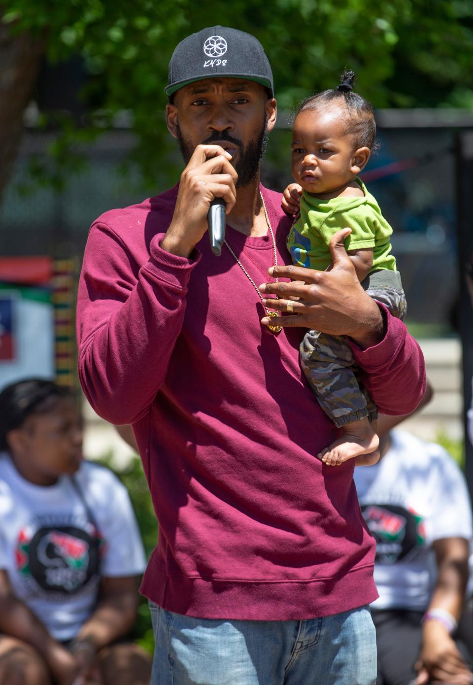 Rodney Saloman of Neptune with his son Ra-sekou, 7 months, talks to the crowd about KYDS, konscious youth development & service. The community comes together at Midtown Commons Park to celebrate the Juneteenth holiday.  Neptune, NJSaturday, June 18, 2022