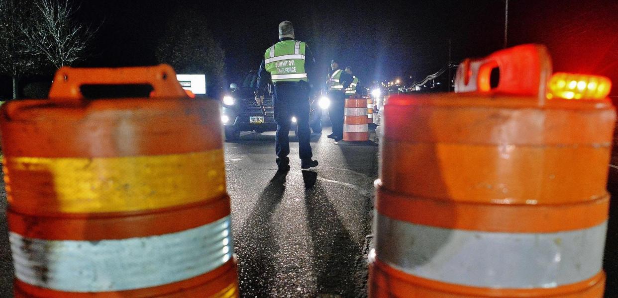 Sgt. Dan Drummond of the Stow Police Department approaches a vehicle at a sobriety checkpoint conducted last year by the Summit County OVI Task Force on East Turkeyfoot Road in Green.