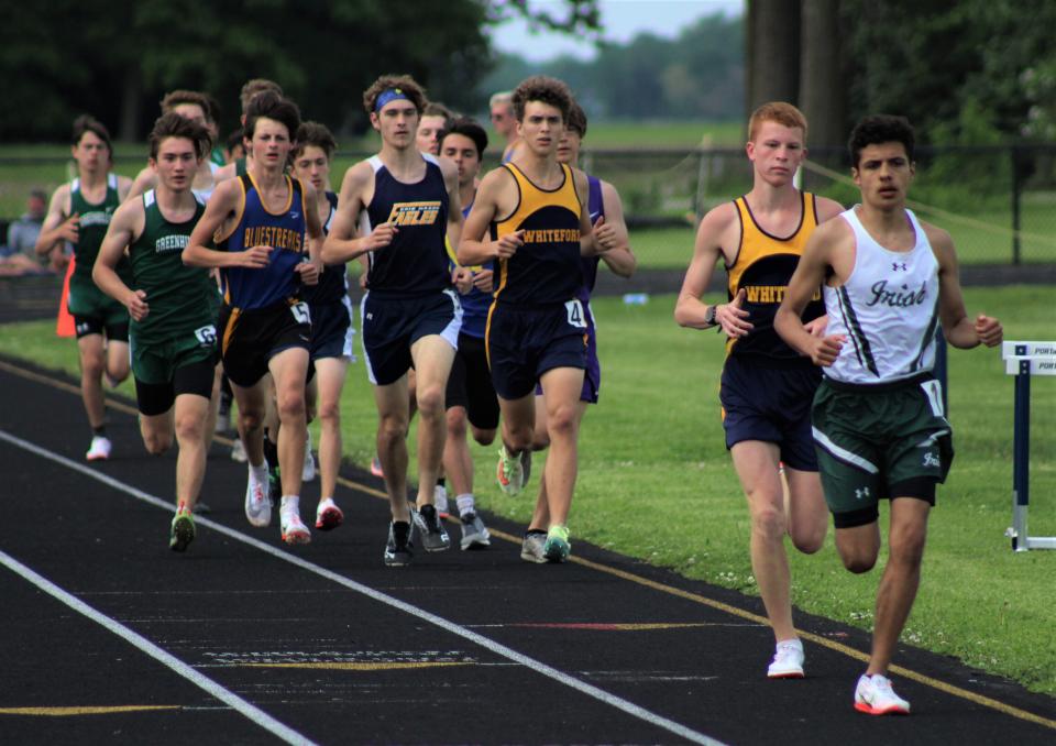 Runners are grouped up in the opening lap of the boys 3,200-meter run during the Division 3 Regional Saturday, May 21, 2022 at Whiteford.