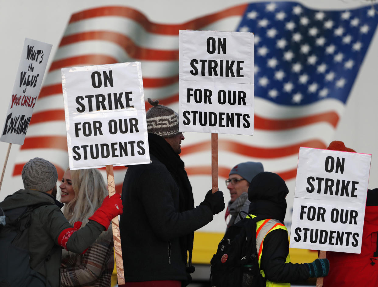 Teachers walk a picket line outside South High School in Denver early Monday. (Photo: David Zalubowski/AP)