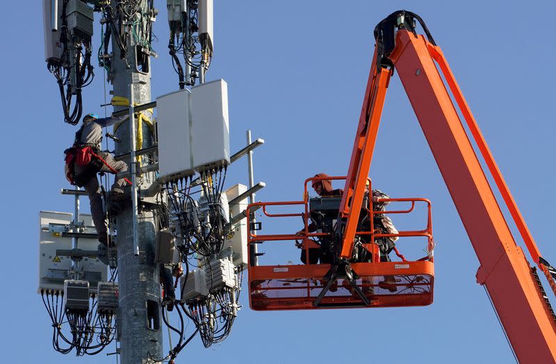 FILE PHOTO: A contract crew from Verizon installs 5G equipment on a tower in Orem