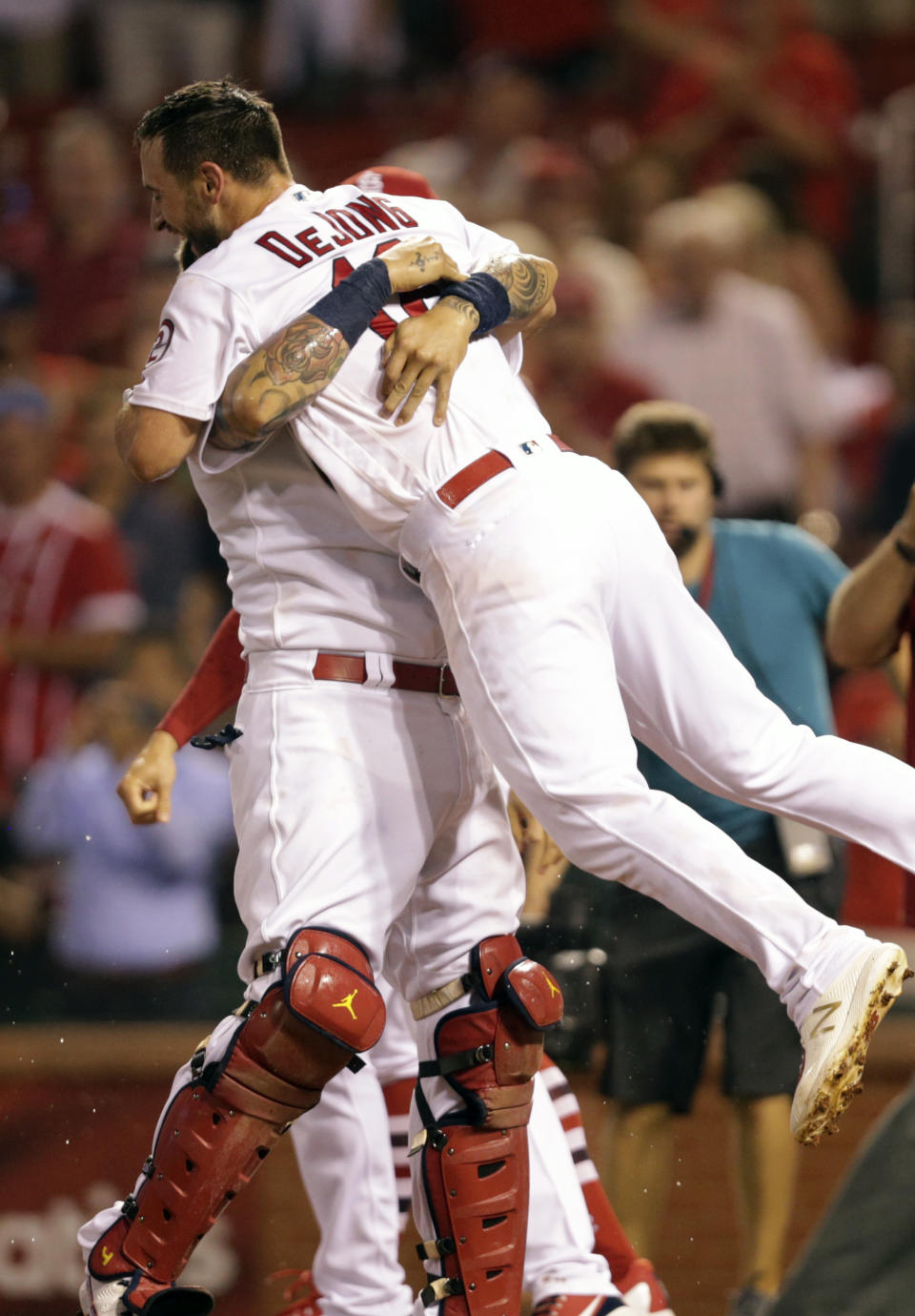 St. Louis Cardinals' Yadier Molina lifts St. Louis Cardinals' Paul DeJong in celebration after he hit a walk-off home run in the ninth inning of a baseball game, Monday, Aug. 13, 2018, in St. Louis. The Cardinals beat the Nationals 7-6. (AP Photo/Tom Gannam)