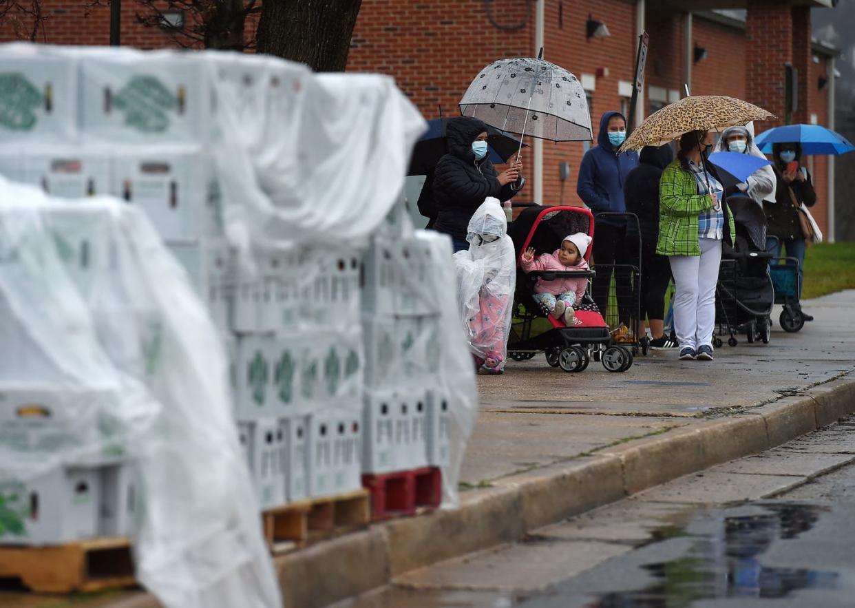 <span class="caption">Lines outside food distribution centers have become a common scene.</span> <span class="attribution"><a class="link " href="https://www.gettyimages.com/detail/news-photo/people-wait-in-a-line-outside-of-padonia-international-news-photo/1229967305?adppopup=true" rel="nofollow noopener" target="_blank" data-ylk="slk:Olivier Douliery/AFP via Getty Images;elm:context_link;itc:0;sec:content-canvas">Olivier Douliery/AFP via Getty Images</a></span>