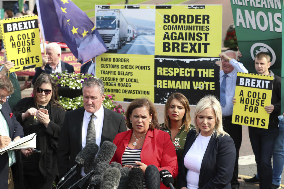 Northern Ireland's Sinn Fein party president Mary Lou McDonald speaks to the media with Sinn Fein Foyle MP Elisha McCallion, second from right, and Sinn Fein deputy leader Michelle O'Neill, right, after their meeting with Britain's Prime Minister Boris Johnson at Stormont House in Belfast, Wednesday July 31, 2019. Northern Ireland, as part of the UK, has an invisible land border with the Republic of Ireland in Europe, which is a main stumbling block to a Brexit deal, and Johnson depends on various Northern Irish political parties for his working majority in parliament. (Liam McBurney/PA via AP)