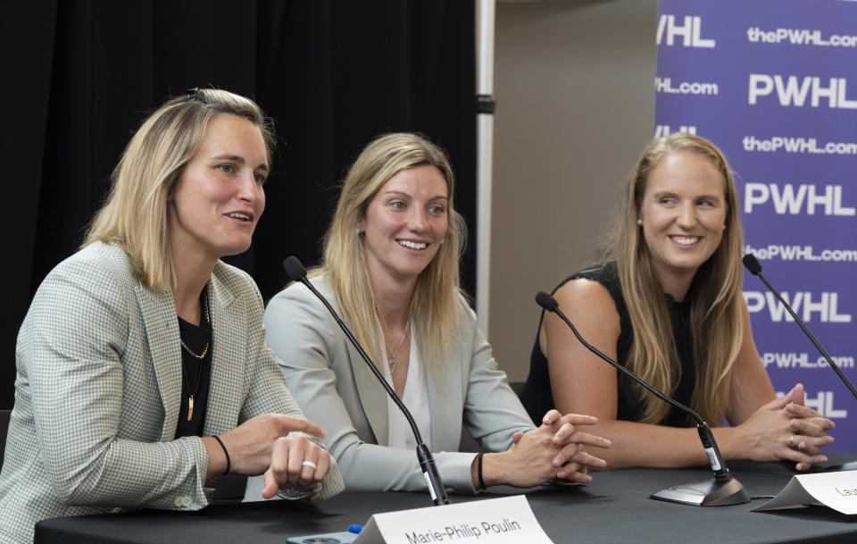 FILE - Canadian hockey players Marie-Philip Poulin, from left, Laura Stacey and Ann-Renee Desbiens, are introduced by the Professional Women's Hockey League as the first three players to sign free agent contracts with the league's Montreal franchise in Montreal, Thursday, Sept. 7, 2023. The newly launched PWHL is taking shape with Hilary Knight back in familiar surroundings in Boston, and Marie-Philip Poulin signing with Montreal. Each of the six franchise's head coaches are expected to be announced on Friday, Sept. 15. (Christinne Muschi/The Canadian Press via AP, File)