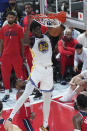 Golden State Warriors' James Wiseman, center, dunks against Washington Wizards during their preseason NBA basketball game, Friday, Sept. 30, 2022, at Saitama Super Arena, in Saitama, north of Tokyo. (AP Photo/Eugene Hoshiko)