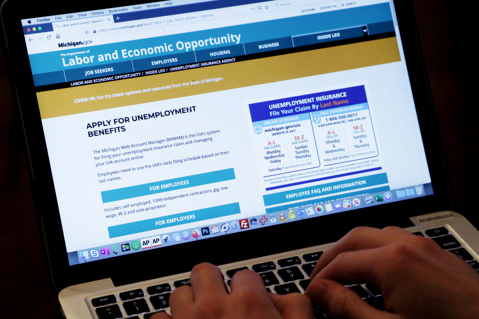 An unemployed worker checks looks at the State of Michigan unemployment site, Wednesday, April 29, 2020, in Detroit. As of mid-April, about 26 million Americans had filed unemployment claims in the first five weeks since governments began ordering people to stay home and some businesses to close as a precaution against spreading the new coronavirus that causes the COVID-19 disease. It's already the worst stretch of job losses in U.S. history. (AP Photo/Carlos Osorio)