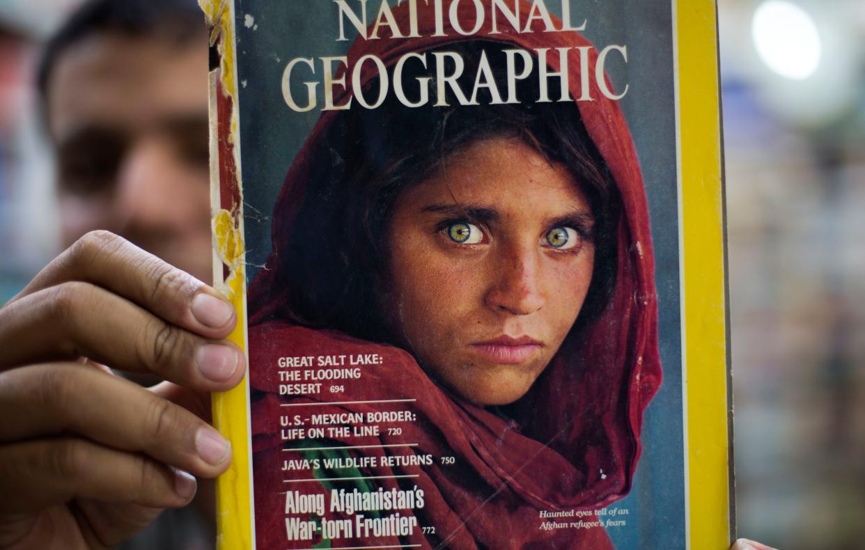 The National Geographic cover of Sharbat Gula is held by a man on Oct. 26, 2016.