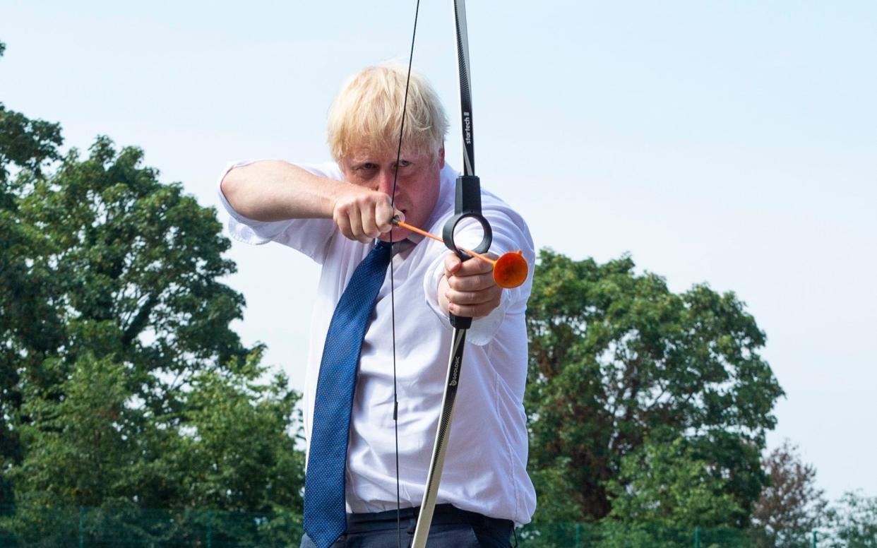 Boris Johnson takes aim on a visit to a school in Upminster, Essex - Lucy Young/Evening Standard/PA