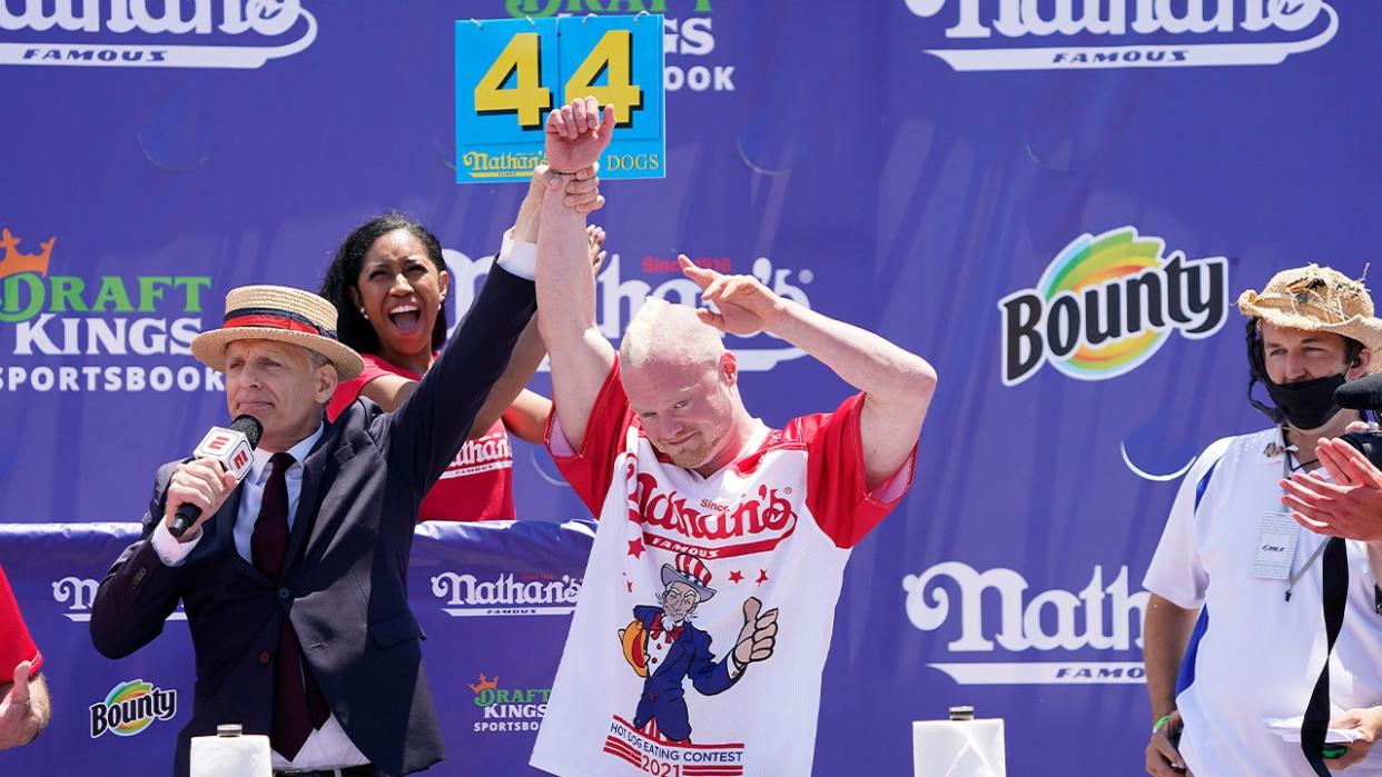<div>NEW YORK, NEW YORK - JULY 04: Third place winner having consumed 44 hot dogs, Nick Wehry raises his arm during the 2021 Nathans Famous Fourth of July International Hot Dog Eating Contest at Coney Island on July 04, 2021 in New York City. (Photo by John Lamparski/Getty Images)</div>