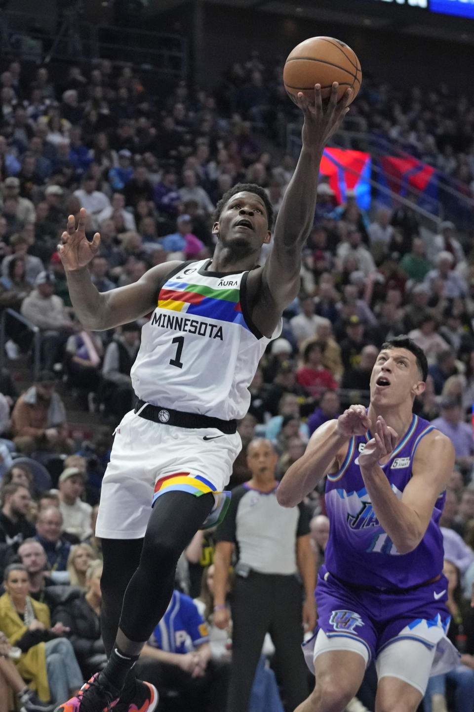 Minnesota Timberwolves guard Anthony Edwards (1) goes to the basket as Utah Jazz forward Simone Fontecchio, right, defends during the first half of an NBA basketball game Wednesday, Feb. 8, 2023, in Salt Lake City. (AP Photo/Rick Bowmer)