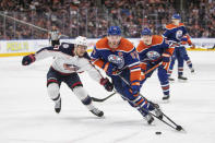 Columbus Blue Jackets' Adam Boqvist (27) chases Edmonton Oilers' Connor McDavid (97) during the second period of an NHL hockey game Tuesday, Jan. 23, 2024, in Edmonton, Alberta. (Amber Bracken/The Canadian Press via AP)