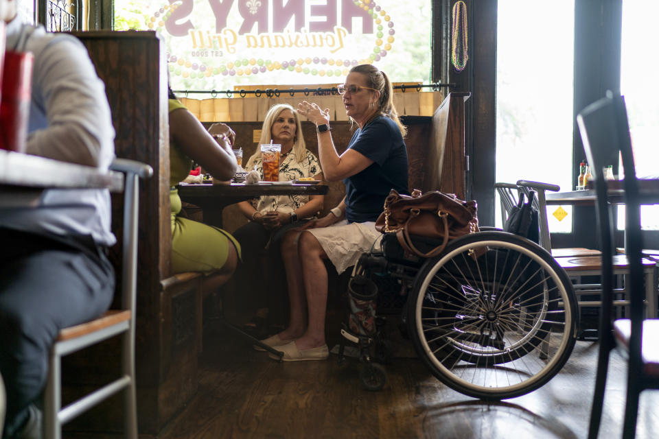 Janet Paulsen, right, enjoys lunch with friends Susan McElvey, center, and TaNesha McAuley, left, at Henry’s Louisiana Grill in Acworth, Ga., Tuesday, Aug. 8, 2023. (AP Photo/David Goldman)