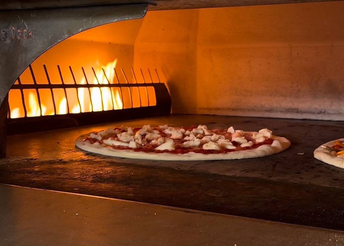Pizza bakes in the oven at Di Fara Pizza Tavern on Friday, June 2, 2023.