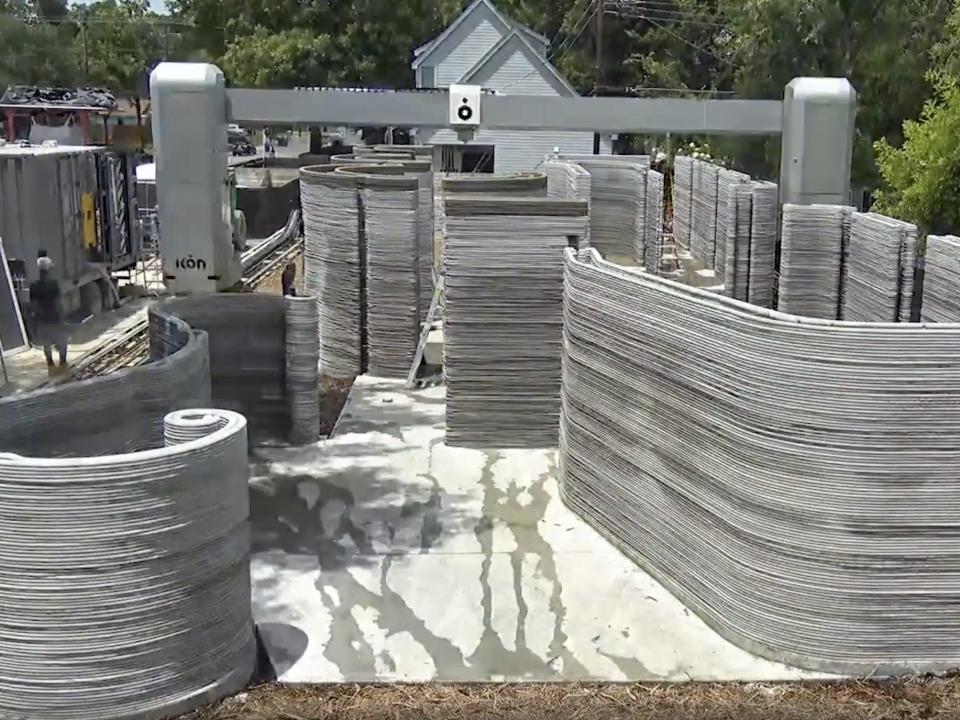 The printed walls of House Zero with the printer standing in the middle of the property.