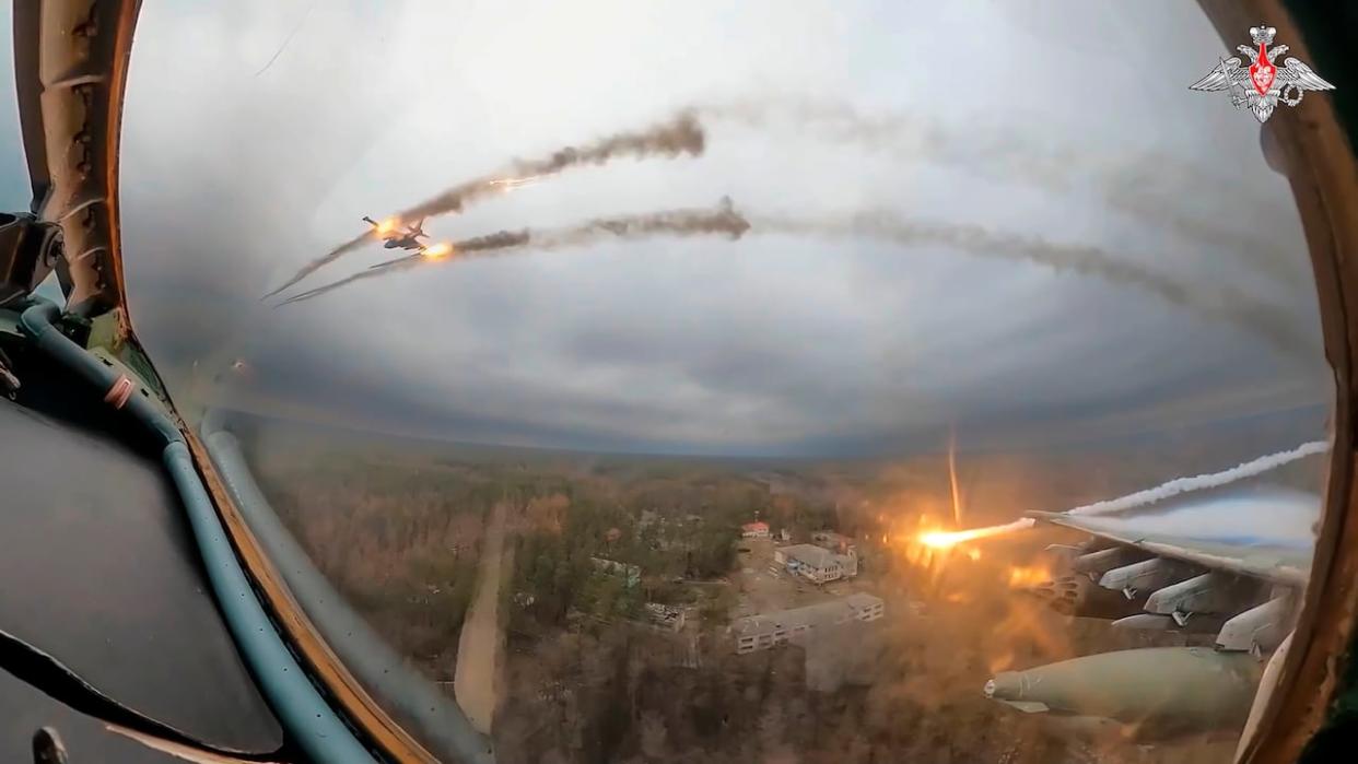 In this photo taken from video released by the Russian Defence Ministry Press Service on Monday, Jan. 22, 2024, a Su-25 warplane is seen from the cockpit of another such aircraft as they fire rockets on a mission over Ukraine. (Russian Defense Ministry Press Service via Associated Press - image credit)
